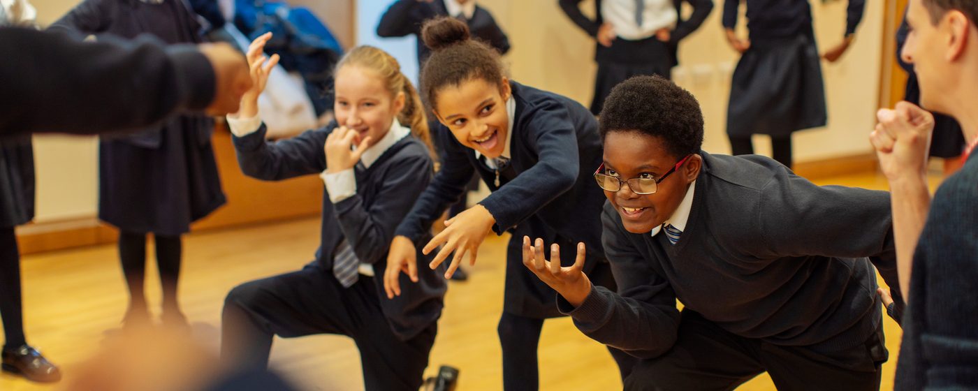 Three students performing in a workshop