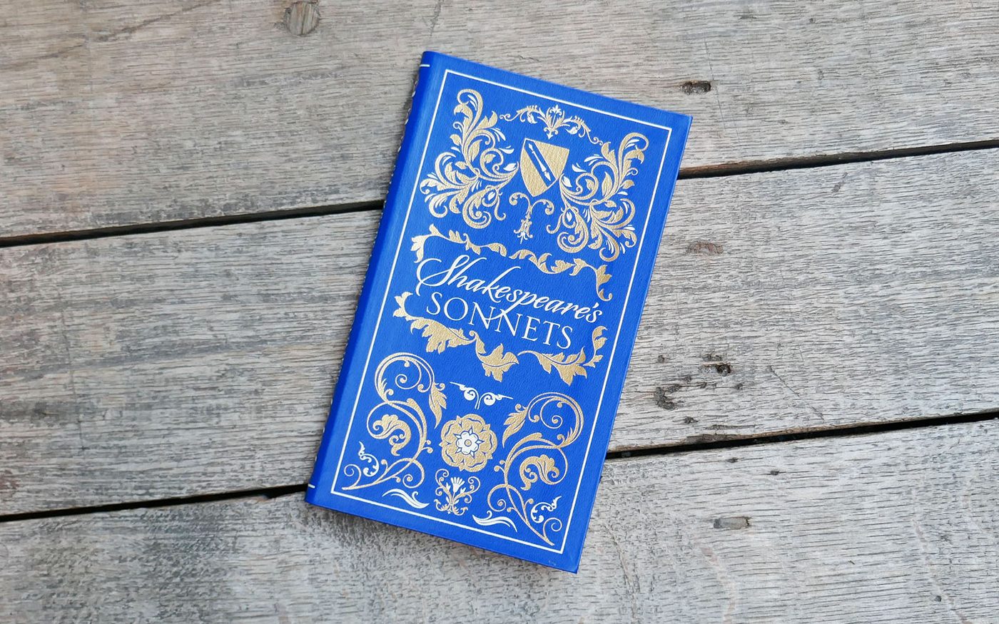 A blue book with gold illustrations. The title reads: Shakespeare's Sonnets