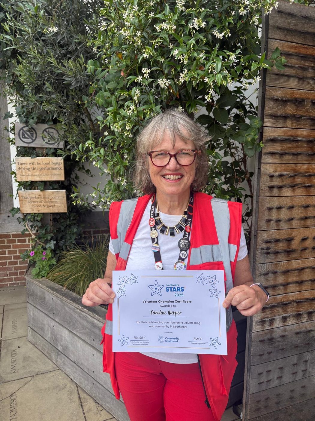 Caroline, one of our volunteer stewards, holding a Volunteer Champion Certificate for contributing to volunteering and community in Southwark.
